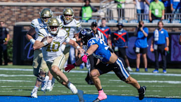 Oct 18, 2025; Durham, North Carolina, USA; Georgia Tech Yellow Jackets quarterback Haynes King (10) runs with the ball and is defended by Duke Blue Devils linebacker Luke Mergott (34) during the first half of the game at Wallace Wade Stadium. Mandatory Credit: Jaylynn Nash-Imagn Images