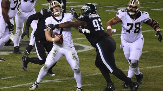 Taysom Hill (7) of the New Orleans Saints is pressured by the Philadelphia Eagles defense 