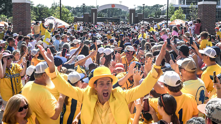 Jesse Cole, owner of the Savannah Bananas, leads the teams greeting fans at Tiger Walk, where players on the Savannah Bananas and Party Animals walked by cheering fans toward Memorial Stadium in Clemson, S.C. Saturday, April 26, 2025. The Bananas world tour stop in Clemson with 81,000 is the most fans they have played in front of, in a stadium normally used for Clemson Tigers football games.