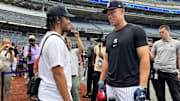 New York Yankees center fielder Aaron Judge talks to New York Knicks guard Jalen Brunson before a game against the New York Mets at Yankee Stadium.