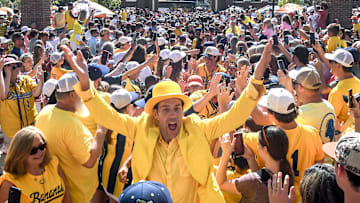 Jesse Cole, owner of the Savannah Bananas, leads the teams greeting fans at Tiger Walk, where players on the Savannah Bananas and Party Animals walked by cheering fans toward Memorial Stadium in Clemson, S.C. Saturday, April 26, 2025. The Bananas world tour stop in Clemson with 81,000 is the most fans they have played in front of, in a stadium normally used for Clemson Tigers football games.