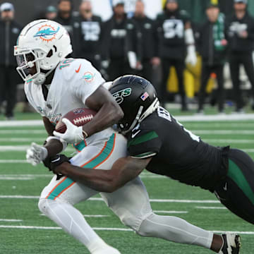 East Rutherford, NJ November 24, 2023 -- Tyreek Hill of Miami is tackled by D.J. Reed of the Jets after making a catch in the first half as the Miami Dolphins defeated the NY Jets 34-13 at MetLife Stadium on November 24, 2023 in East Rutherford, NJ to play in the first Black Friday NFL game.