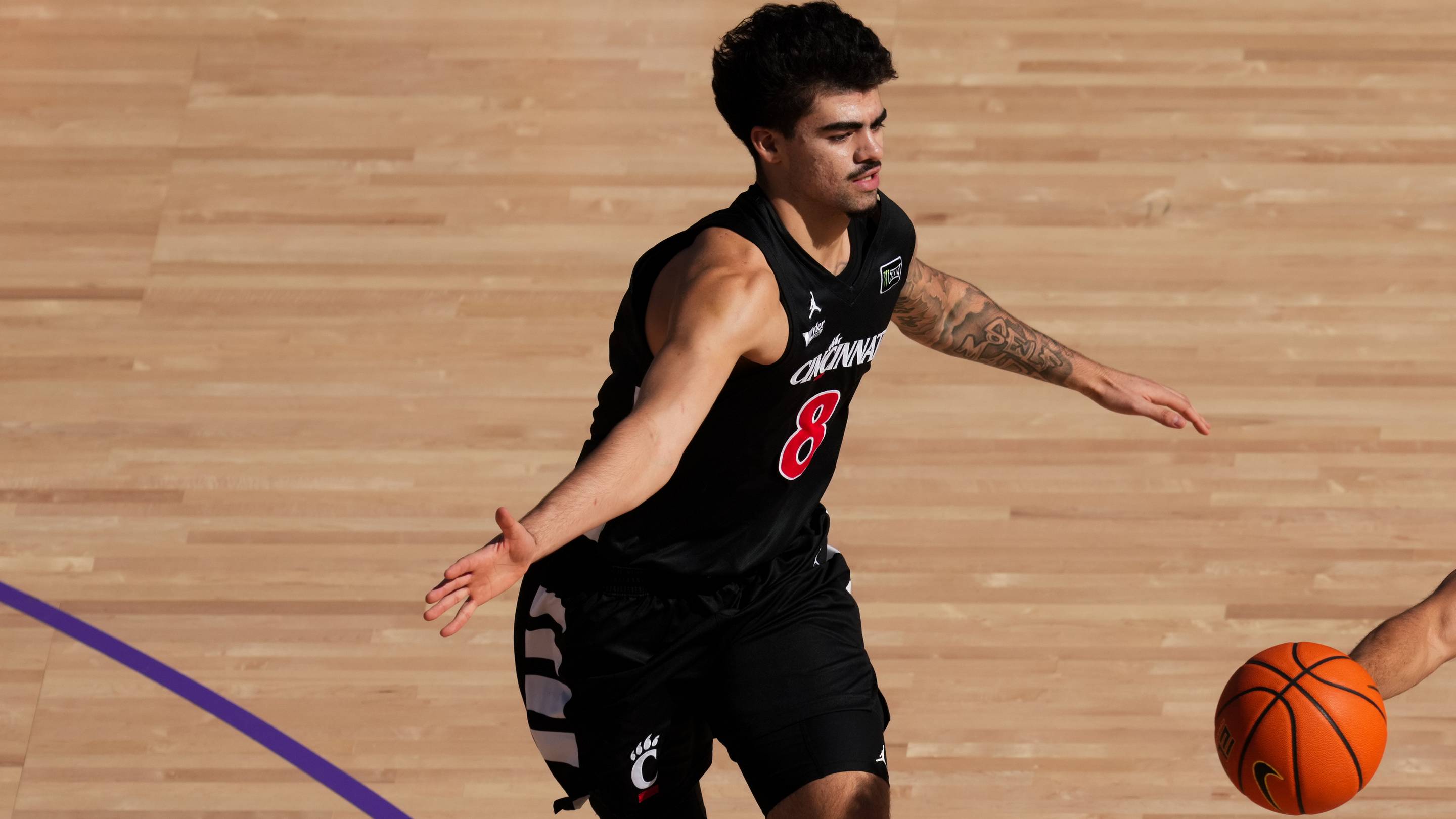 Oct 7, 2026; Mason, OH, USA; Ohio State Buckeyes guard John Mobley Jr. (0) passes the ball against Cincinnati Bearcats forward Tyler Tejada (8) in the first half during the 2026 CareSource Invitational at the Lindner Family Tennis Center. Mandatory Credit: Aaron Doster-Imagn Images | IMAGN IMAGES vi
