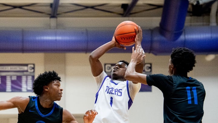 Dec 17, 2023; Bexley, Ohio, USA;
Pickerington Central's Juwan Turner (1) goes for a jump shot against Richmond Heights' Jeremy Wilson (5) and Richmond Heights' Dorian Jones (11) during their game on Sunday, Dec. 17, 2023 at the Capital Center.