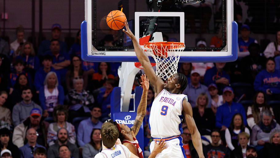 Florida Gators center Rueben Chinyelu blocks a shot from Alabama Crimson Tide forward Amari Allen.