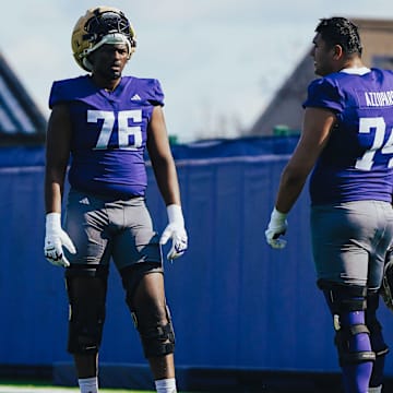 Elishah Jackett (76) chats up Drew Azzopardi during a break in spring ball. 