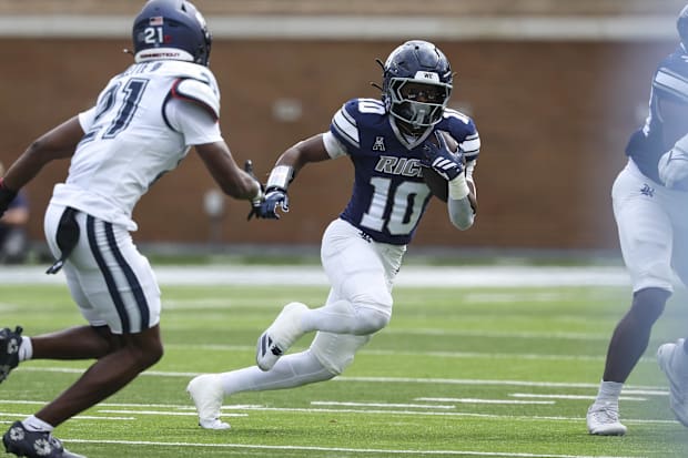 Rice running back Quinton Jackson runs with the ball against UConn .