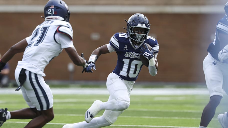 Rice running back Quinton Jackson runs with the ball against UConn .
