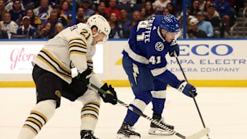 Mar 27, 2024; Tampa, Florida, USA; Tampa Bay Lightning right wing Mitchell Chaffee (41) scores a goal as Boston Bruins left wing James van Riemsdyk (21) attempted to defend during the first period at Amalie Arena. Mandatory Credit: Kim Klement Neitzel-Imagn Images