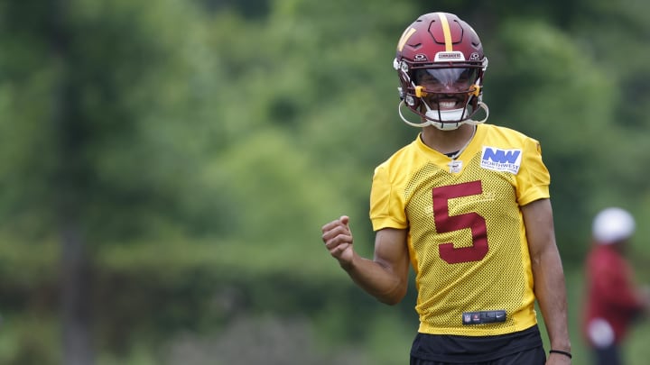 Jun 5, 2024; Ashburn, VA, USA; Washington Commanders quarterback Jayden Daniels (5) gestures during OTA workouts at Commanders Park. Mandatory Credit: Geoff Burke-USA TODAY Sports