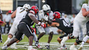 Aug 28, 2025; Orlando, Florida, USA; UCF Knights running back Myles Montgomery (22) is tackled by Jacksonville State Gamecocks linebacker Thaxton Gallagher (49) during the first quarter at Acrisure Bounce House. Mandatory Credit: Mike Watters-Imagn Images