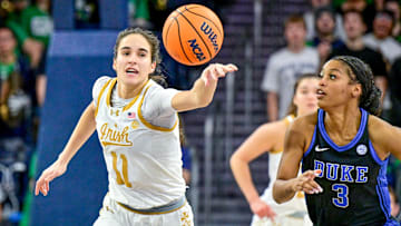Feb 17, 2025; South Bend, Indiana, USA; Notre Dame Fighting Irish guard Sonia Citron (11) reaches for the ball as Duke Blue Devils guard Ashlon Jackson (3) defends in the second half at the Purcell Pavilion. 