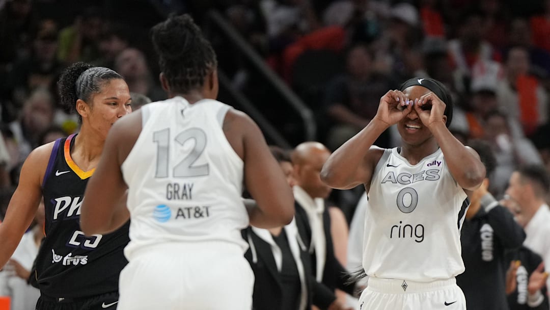 Jun 29, 2025; Phoenix, Arizona, USA; Las Vegas Aces guard Jackie Young (0) and guard Chelsea Gray (12) celebrate against the Phoenix Mercury in the second half at Footprint Center.