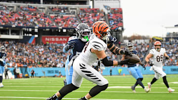 Dec 15, 2024; Nashville, Tennessee, USA;  Cincinnati Bengals defensive end Sam Hubbard (94) makes a touchdown catch over Tennessee Titans linebacker James Williams (52) during the first half at Nissan Stadium. Mandatory Credit: Steve Roberts-Imagn Images
