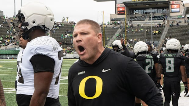 Oregon defensive coordinator Tosh Lupoi directs his players during warmups before the Spring Game at Autzen in Eugene