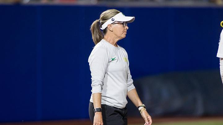 May 30, 2025; Oklahoma City, OK, USA;  Oregon Ducks head coach Melyssa Lombardi heads to the mound to make a pitching change in the sixth inning against the Ole Miss Rebels during the NCAA Softball Women's College World Series at Devon Park. Mandatory Credit: Brett Rojo-Imagn Images