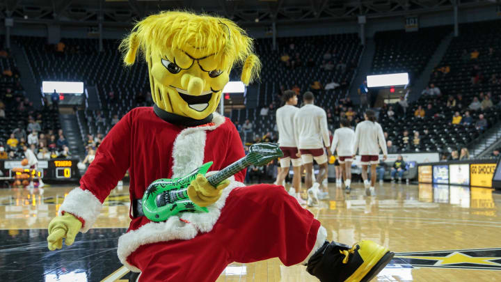 Dec 22, 2022; Wichita, Kansas, USA; Wichita State Shockers mascot WuShock plays air guitar prior to the game between the Wichita State Shockers and the Texas Southern Tigers at Charles Koch Arena. Mandatory Credit: William Purnell-USA TODAY Sports