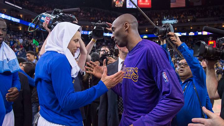 Oakland, CA, USA; Golden State Warriors guard Stephen Curry (30, left) shakes hands with Los Angeles Lakers forward Kobe Bryant (24, right) after the game at Oracle Arena. The Warriors defeated the Lakers 116-98. Mandatory Credit: Kyle Terada-USA TODAY Sports