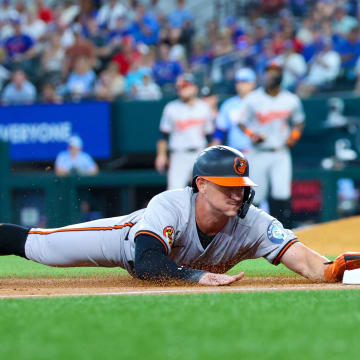 Jul 21, 2024; Arlington, Texas, USA;  Baltimore Orioles left fielder Austin Hays (21) slides into third base during the second inning against the Texas Rangers at Globe Life Field.