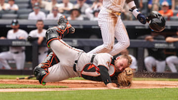 Jun 22, 2025; Bronx, New York, USA; New York Yankees second baseman Jazz Chisholm Jr. (13) collides with Baltimore Orioles catcher Maverick Handley (98) at home plate during the second inning at Yankee Stadium. 