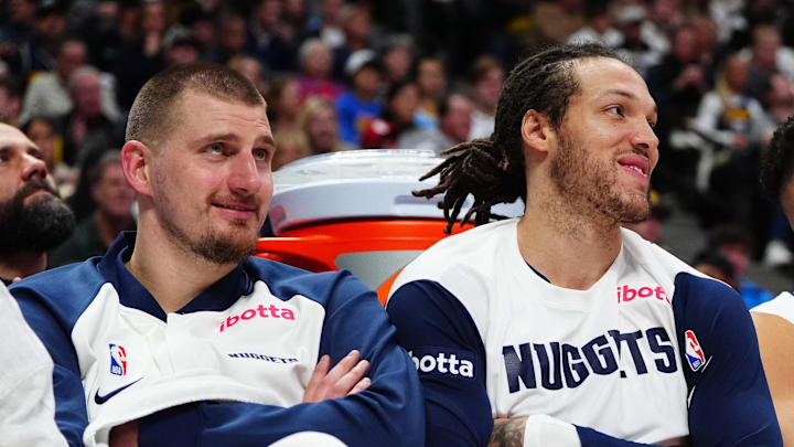 Dec 23, 2024; Denver, Colorado, USA; Denver Nuggets center Nikola Jokic (15) and forward Aaron Gordon (32) and forward Michael Porter Jr. (1) on the bench in the fourth quarter against the Phoenix Suns at Ball Arena. Mandatory Credit: Ron Chenoy-Imagn Images