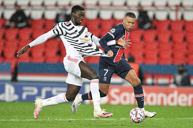 Axel Tuanzebe (left) tangling with Kylian Mbappé.