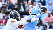 Oct 25, 2025; Chapel Hill, North Carolina, USA; North Carolina Tar Heels quarterback Gio Lopez (7) passes the ball as Virginia Cavaliers defensive end Mitchell Melton (17) pressures in the third quarter at Kenan Stadium. 