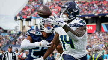 Seattle Seahawks wide receiver DK Metcalf (14) pulls in a touchdown past Tennessee Titans cornerback Tre Avery (23) during the fourth quarter at Nissan Stadium in Nashville, Tenn., Sunday, Dec. 24, 2023.