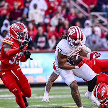 Nov 1, 2025; College Park, Maryland, USA;  Indiana Hoosiers tight end Riley Nowakowski (37) rushes through Maryland Terrapins defensive lineman Nahsir Taylor (40) tackle attempt  during the second quarter at SECU Stadium. Mandatory Credit: Tommy Gilligan-Imagn Images