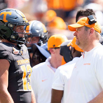 Tennessee head coach Josh Heupel speaks with Tennessee quarterback Gaston Moore (13) with Tennessee quarterback Nico Iamaleava (8) behind him, during a game between Tennessee and Chattanooga, Saturday, Aug. 31, 2024.