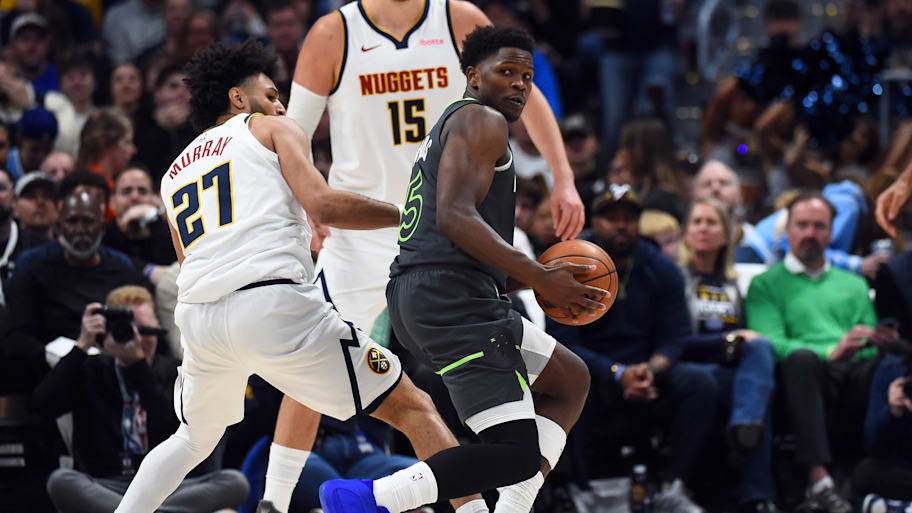 Minnesota Timberwolves guard Anthony Edwards handles the ball against Denver Nuggets guard Jamal Murray.