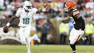 Dec 29, 2024; Cleveland, Ohio, USA; Miami Dolphins quarterback Tyler Huntley (18) is defended by Cleveland Browns linebacker Jordan Hicks (58) during the second quarter at Huntington Bank Field. Mandatory Credit: Scott Galvin-Imagn Images