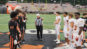 Massillon (Ohio) and Bergen Catholic (New Jersey) players receive instructions at the opening coin toss on Septmeber 6, 2024. 