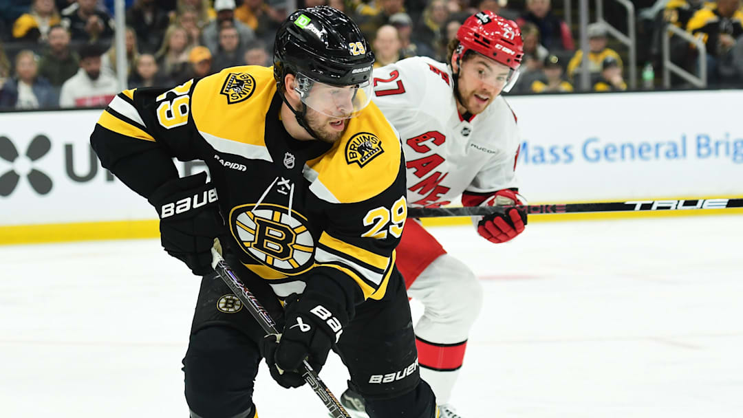 Apr 5, 2025; Boston, Massachusetts, USA; Boston Bruins defenseman Parker Wotherspoon (29) controls the puck away from Carolina Hurricanes center Tyson Jost (27) during the second period at TD Garden. Mandatory Credit: Bob DeChiara-Imagn Images