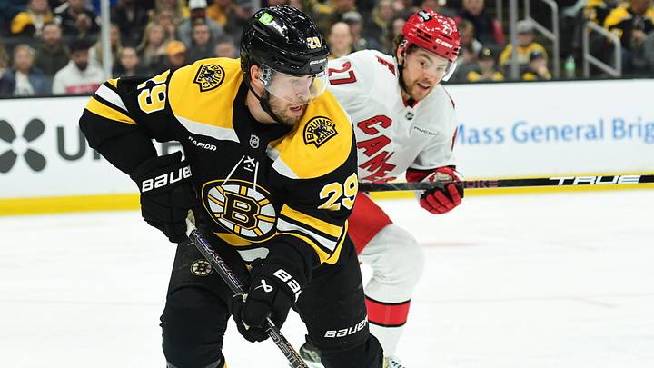 Apr 5, 2025; Boston, Massachusetts, USA; Boston Bruins defenseman Parker Wotherspoon (29) controls the puck away from Carolina Hurricanes center Tyson Jost (27) during the second period at TD Garden. Mandatory Credit: Bob DeChiara-Imagn Images