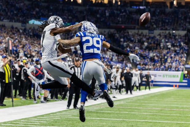 Indianapolis Colts cornerback JuJu Brents breaks up a pass in a blue jersey.