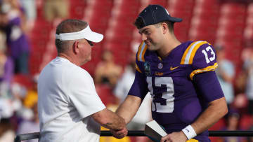 Jan 1, 2024; Tampa, FL, USA; LSU Tigers quarterback Garrett Nussmeier (13) is congratulated by head coach Brian Kelly after being awarded the MVP award after beating the Wisconsin Badgers in the ReliaQuest Bowl at Raymond James Stadium. Mandatory Credit: Nathan Ray Seebeck-USA TODAY Sports