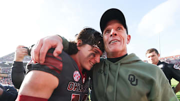 Nov 22, 2025; Norman, Oklahoma, USA;  Oklahoma Sooners quarterback John Mateer (10) hugs Oklahoma Sooners head coach Brent Venables after the game against the Missouri Tigers at Gaylord Family-Oklahoma Memorial Stadium. Mandatory Credit: Kevin Jairaj-Imagn Images