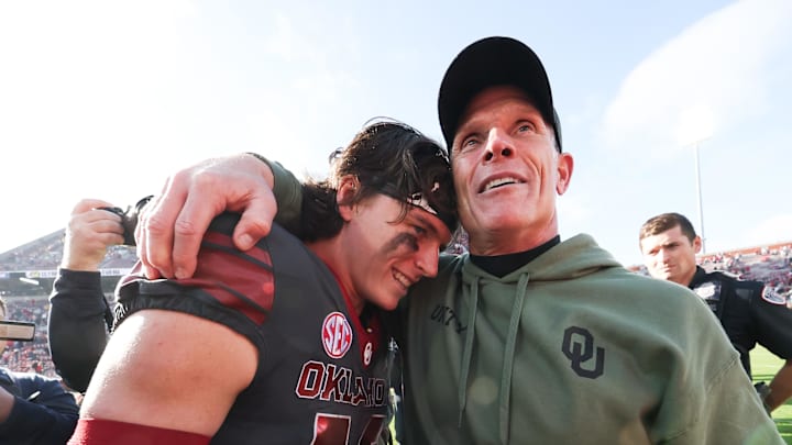 Nov 22, 2025; Norman, Oklahoma, USA;  Oklahoma Sooners quarterback John Mateer (10) hugs Oklahoma Sooners head coach Brent Venables after the game against the Missouri Tigers at Gaylord Family-Oklahoma Memorial Stadium. Mandatory Credit: Kevin Jairaj-Imagn Images