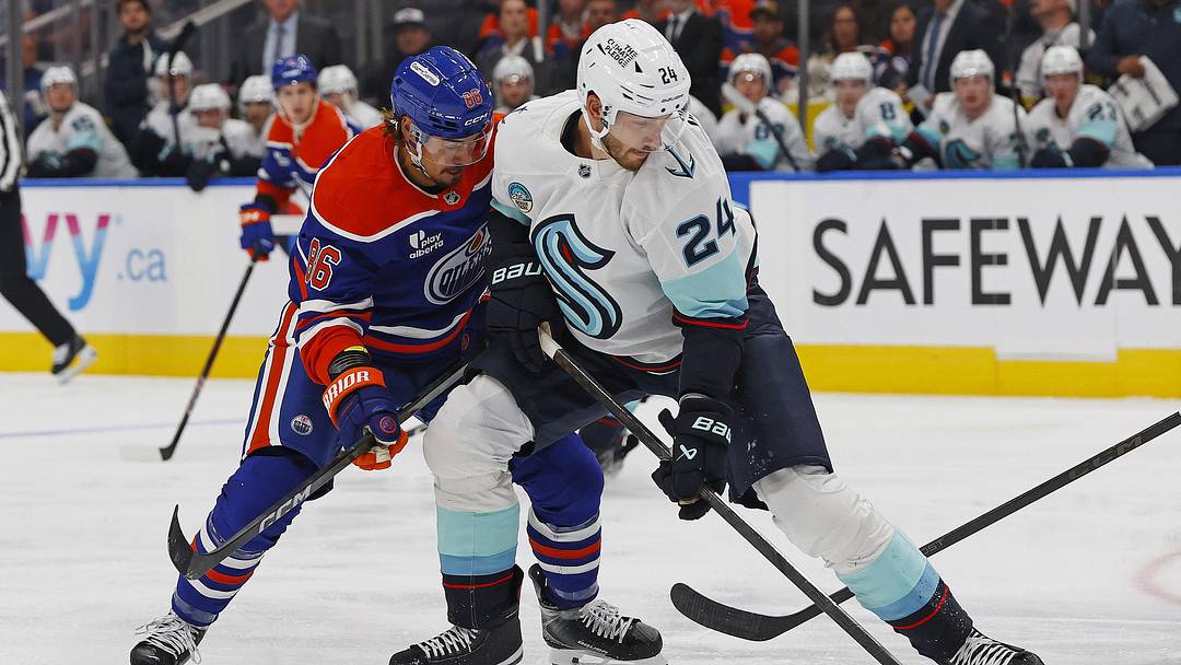 Sep 24, 2025; Edmonton, Alberta, CAN; Edmonton Oilers forward David Tomasek (86) and Seattle Kraken defensemen Jamie Oleksiak (24) battle for a loose puck during the first period at Rogers Place. Mandatory Credit: Perry Nelson-Imagn Images