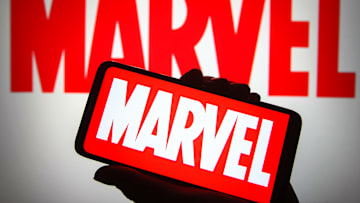 In this photo illustration a Marvel logo is seen on a...