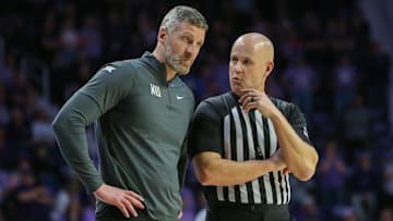 Feb 26, 2024; Manhattan, Kansas, USA; West Virginia Mountaineers interim head coach Josh Eilert listens to an official during overtime against the Kansas State Wildcats at Bramlage Coliseum. Mandatory Credit: Scott Sewell-Imagn Images