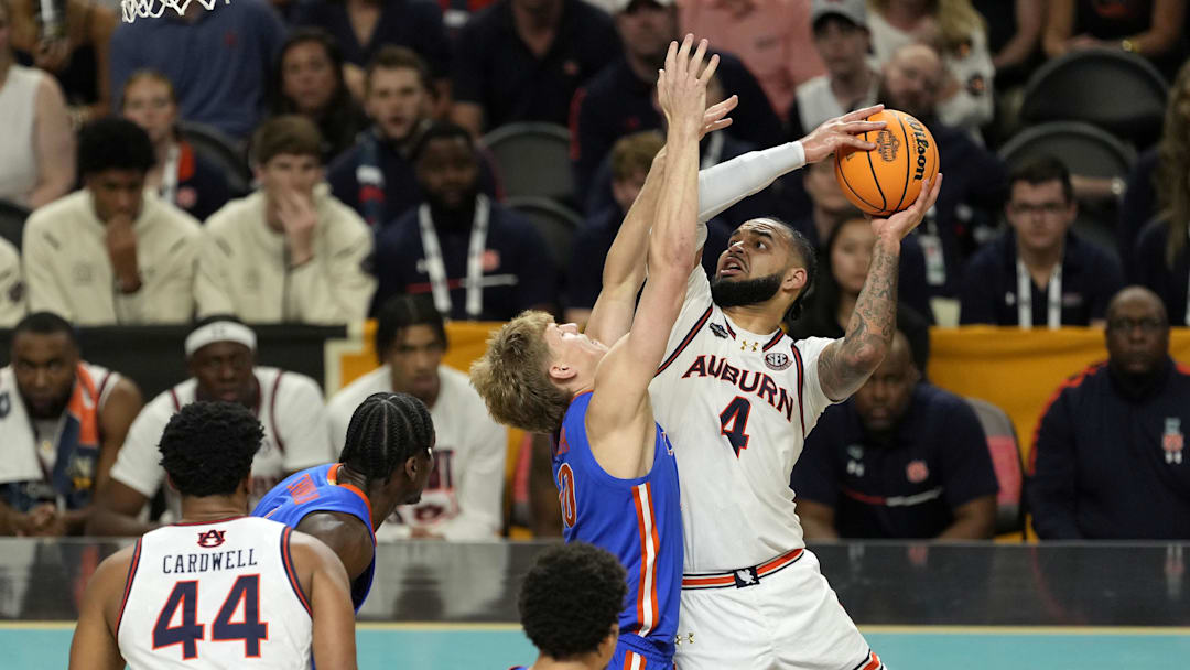 Apr 5, 2025; San Antonio, TX, USA; Auburn Tigers forward Johni Broome (4) shoots the ball on Florida Gators forward Thomas Haugh (10) during the second half in the semifinals of the men's Final Four of the 2025 NCAA Tournament at Alamodome. Mandatory Credit: Scott Wachter-Imagn Images

