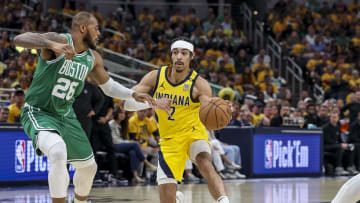 May 27, 2024; Indianapolis, Indiana, USA; Indiana Pacers guard Andrew Nembhard (2) dribbles the ball while Boston Celtics forward Xavier Tillman (26) blocks during the second quarter during game four of the eastern conference finals for the 2024 NBA playoffs at Gainbridge Fieldhouse. Mandatory Credit: Trevor Ruszkowski-USA TODAY Sports