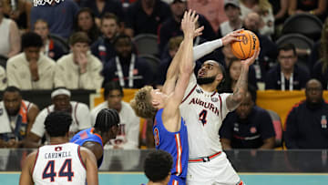 Apr 5, 2025; San Antonio, TX, USA; Auburn Tigers forward Johni Broome (4) shoots the ball on Florida Gators forward Thomas Haugh (10) during the second half in the semifinals of the men's Final Four of the 2025 NCAA Tournament at Alamodome. Mandatory Credit: Scott Wachter-Imagn Images

