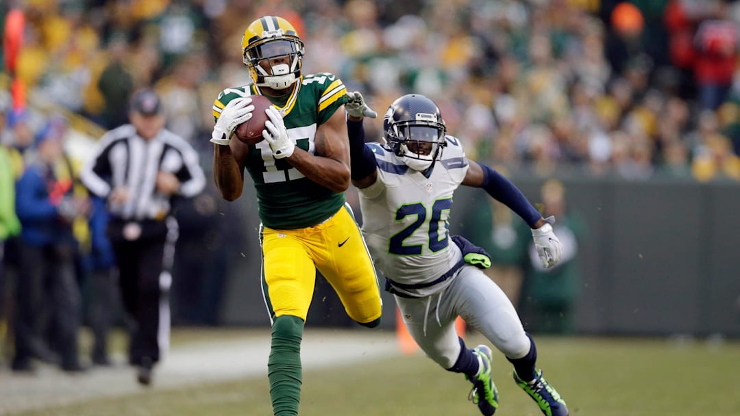 Green Bay Packers wide receiver Davante Adams (17) eludes Seattle Seahawks cornerback Jeremy Lane (20) for a 66 yard touchdown pass from Green Bay Packers quarterback Aaron Rodgers (12) in the first quarter during the Green Bay Packers and Seattle Seahawks NFL football game at Lambeau Field in Green Bay Wisconsin, Sunday, December 11, 2016.