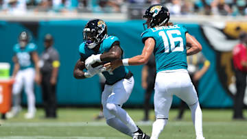 Sep 7, 2025; Jacksonville, Florida, USA; Jacksonville Jaguars quarterback Trevor Lawrence (16) hands off to running back Tank Bigsby (4) against the Carolina Panthers during the first half at EverBank Stadium. Mandatory Credit: Morgan Tencza-Imagn Images