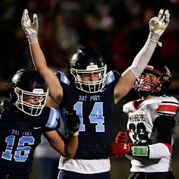 Bay Port High School's Brady Suda (14) celebrates a touchdown during a WIAA Division 1 semifinal versus Muskego High School at the University of Wisconsin Oshkosh's Titan Stadium on Nov. 14, 2025.