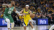 May 27, 2024; Indianapolis, Indiana, USA; Indiana Pacers guard Andrew Nembhard (2) dribbles the ball while Boston Celtics forward Xavier Tillman (26) blocks during the second quarter during game four of the eastern conference finals for the 2024 NBA playoffs at Gainbridge Fieldhouse. Mandatory Credit: Trevor Ruszkowski-USA TODAY Sports
