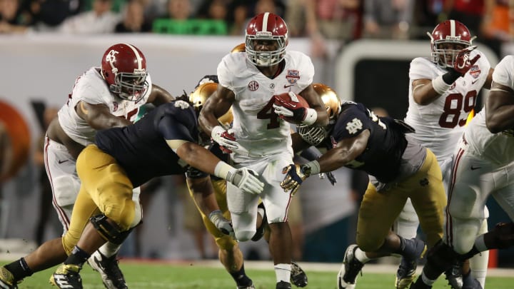 Jan 7, 2013; Miami, FL, USA; Alabama Crimson Tide running back T.J .Yeldon (4) runs with the ball against the Notre Dame Fighting Irish during the 2013 BCS Championship game at Sun Life Stadium. Alabama won 42-14.  